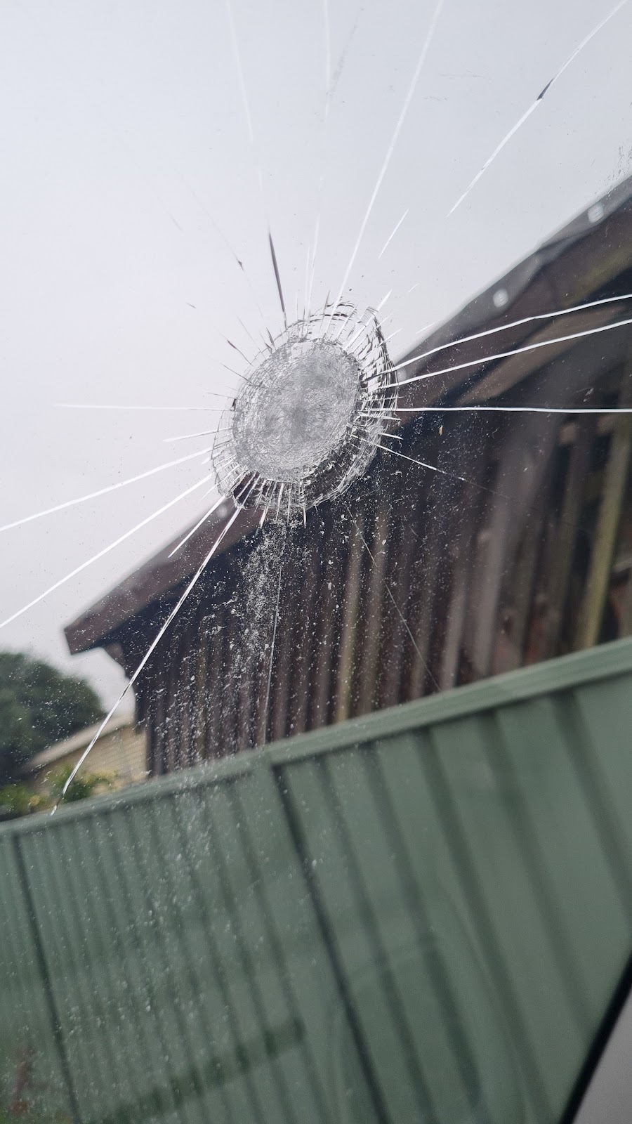 A windscreen with a star-shaped stone chip and cracks running from it